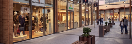 Shopping street with branded stores and modern architecture at Profuse Properties.